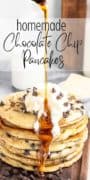 A stack of chocolate chip pancakes topped with whipped cream and syrup being drizzled over them.
