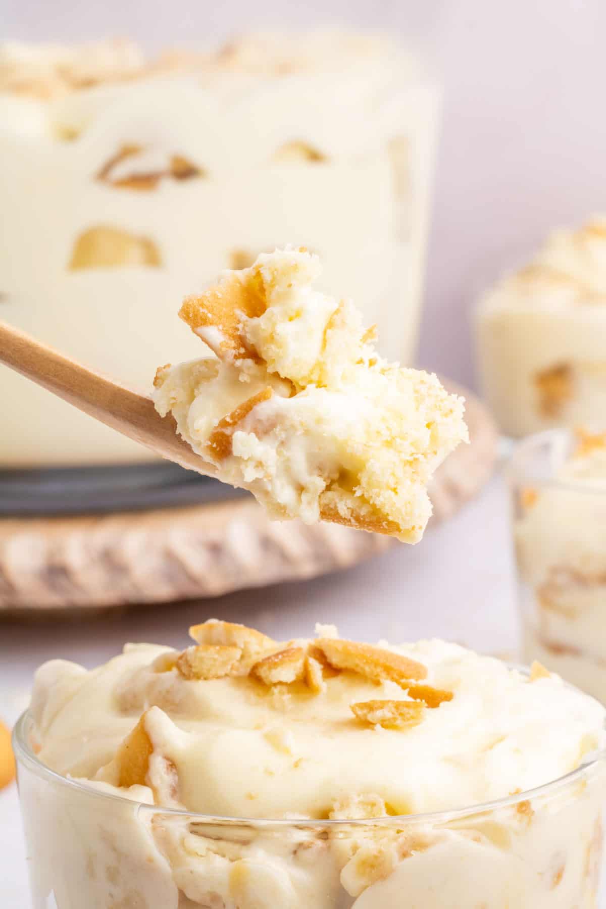 A scoop of banana pudding being spooned out of a dessert bowl.