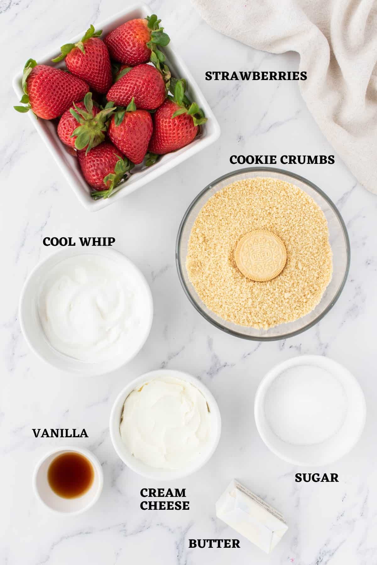 Labeled ingredients needed to make mini strawberry tartlets.
