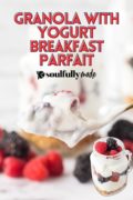 A Pinterest image with a spoon of yogurt parfait with raspberries and blackberries an a jar of the parfait at the bottom.