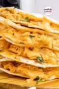 Air fryer buffalo chicken quesadillas stacked in a pile.