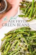 Air fryer green beans on a plate with Parmesan cheese sprinkled on top.