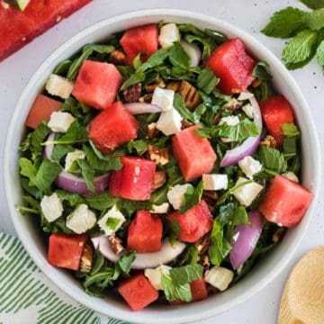 An arugula salad with watermelon and feta.