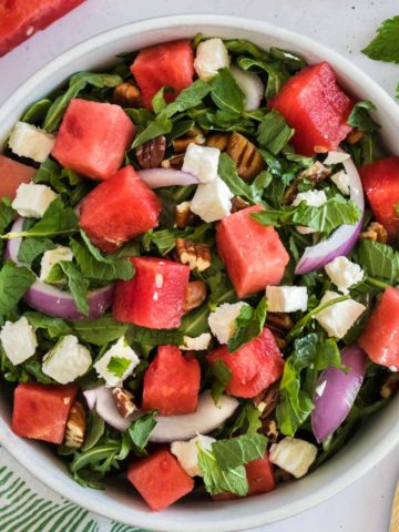 An arugula salad with watermelon and feta.