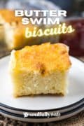 One butter swim biscuit served on a stack of plates for a Pinterest image.