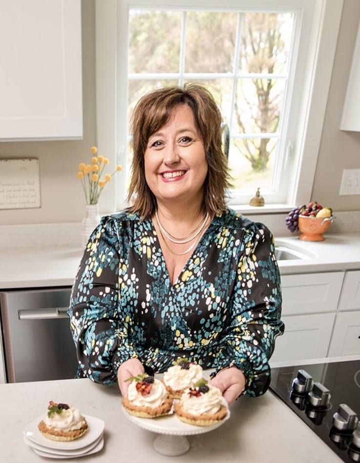 Nikki in the kitchen with key lime tarts on the counter.