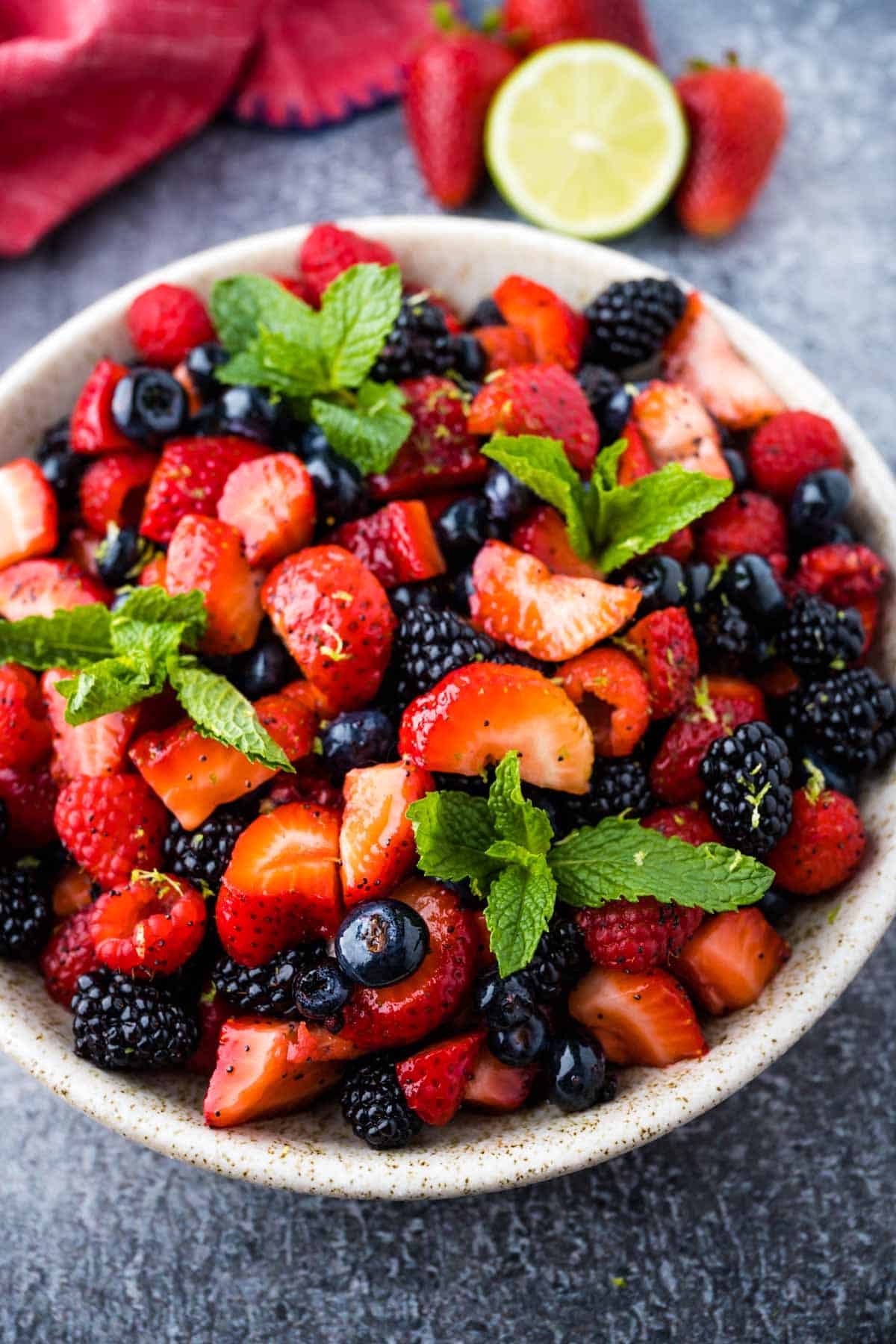 A bowl of vibrant mixed berry fruit salad tossed in a poppy seed dressing.