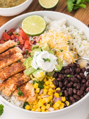 A chicken burrito bowl on a white table.