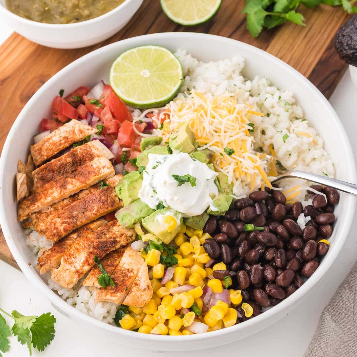 A chicken burrito bowl on a white table.