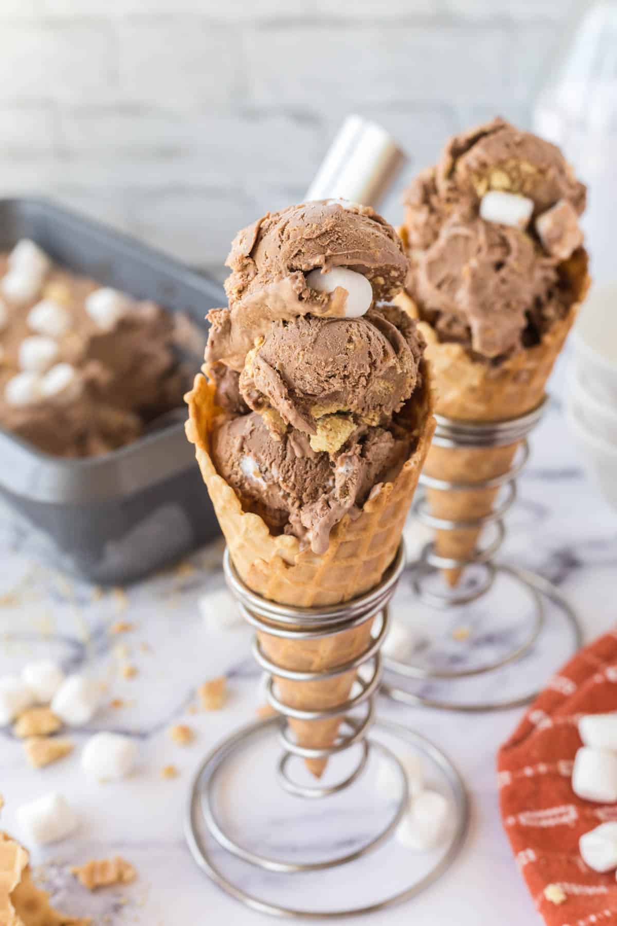 Two waffle cones filled with Chocolate S'mores Ice Cream.