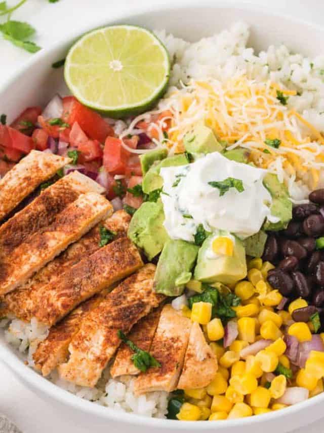A white bowl filled with all the ingredients needed to assemble a chicken burrito bowl.