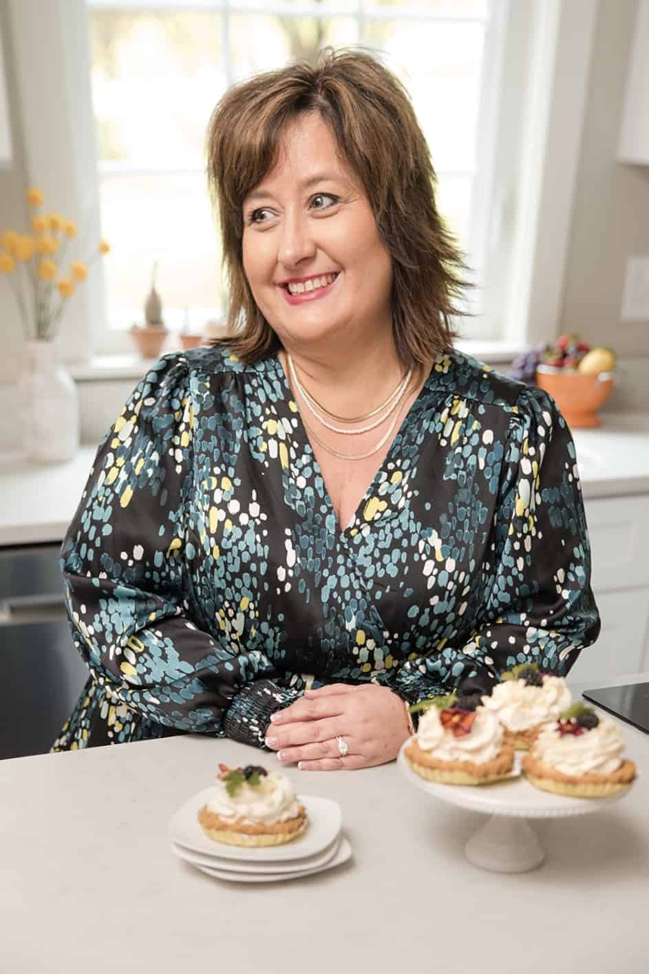 Nikki in the kitchen with key lime tarts on the counter.