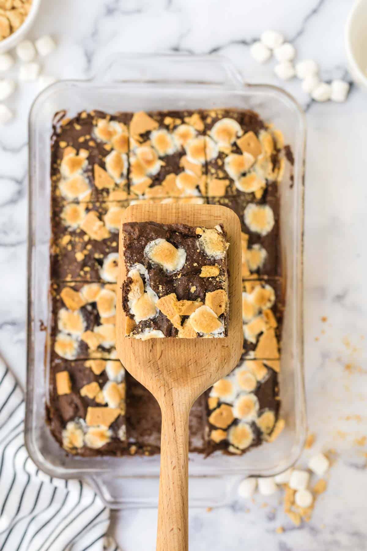 A sliced s'mores brownie on a wooden spatula.
