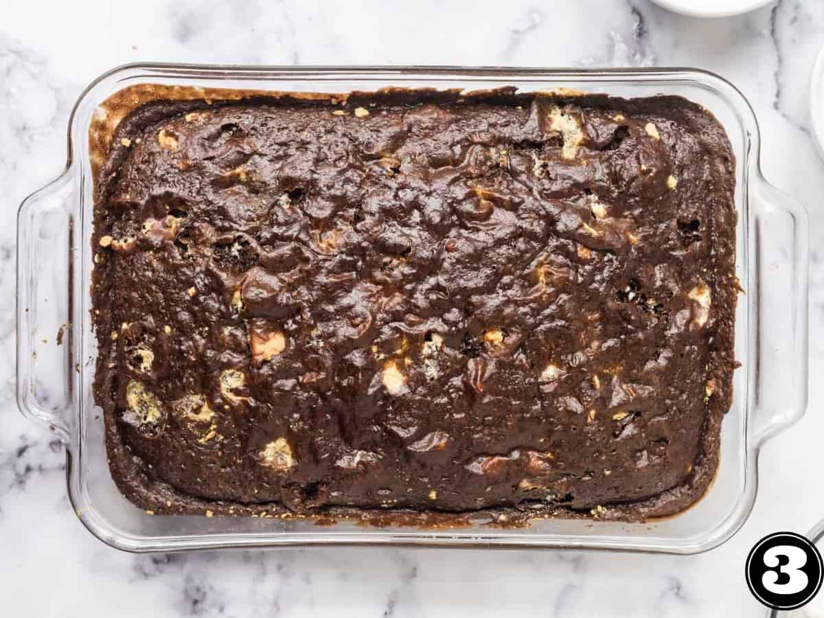 A baked s'mores cake in a glass 9 X 13 pan.