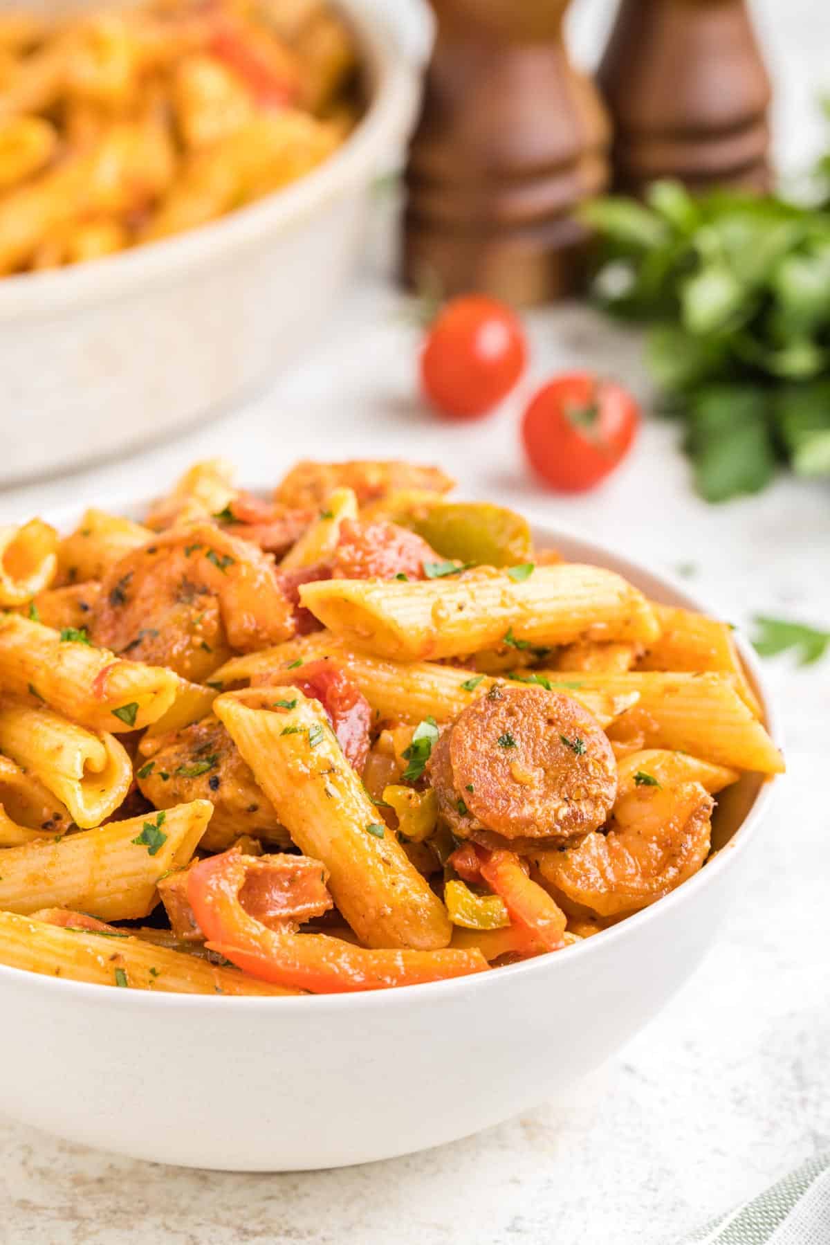 A white bowl filled with a serving of cajun jambalaya pasta.