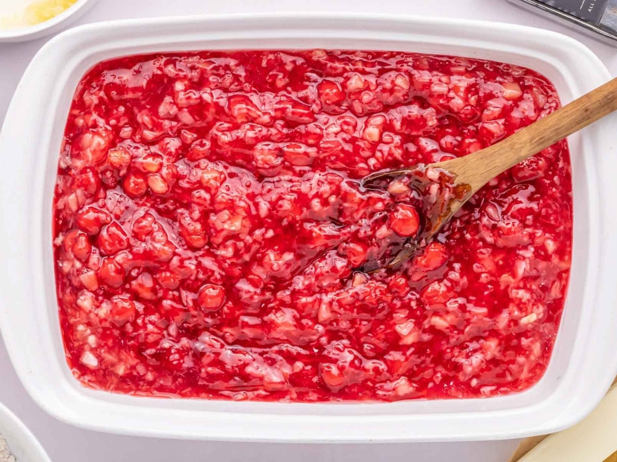 Cherry pie filling and crushed pineapple stirred together in a baking dish.