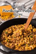 A wooden spoon is stirring a skillet pan filled with One Pot Hamburger Helper Recipe.