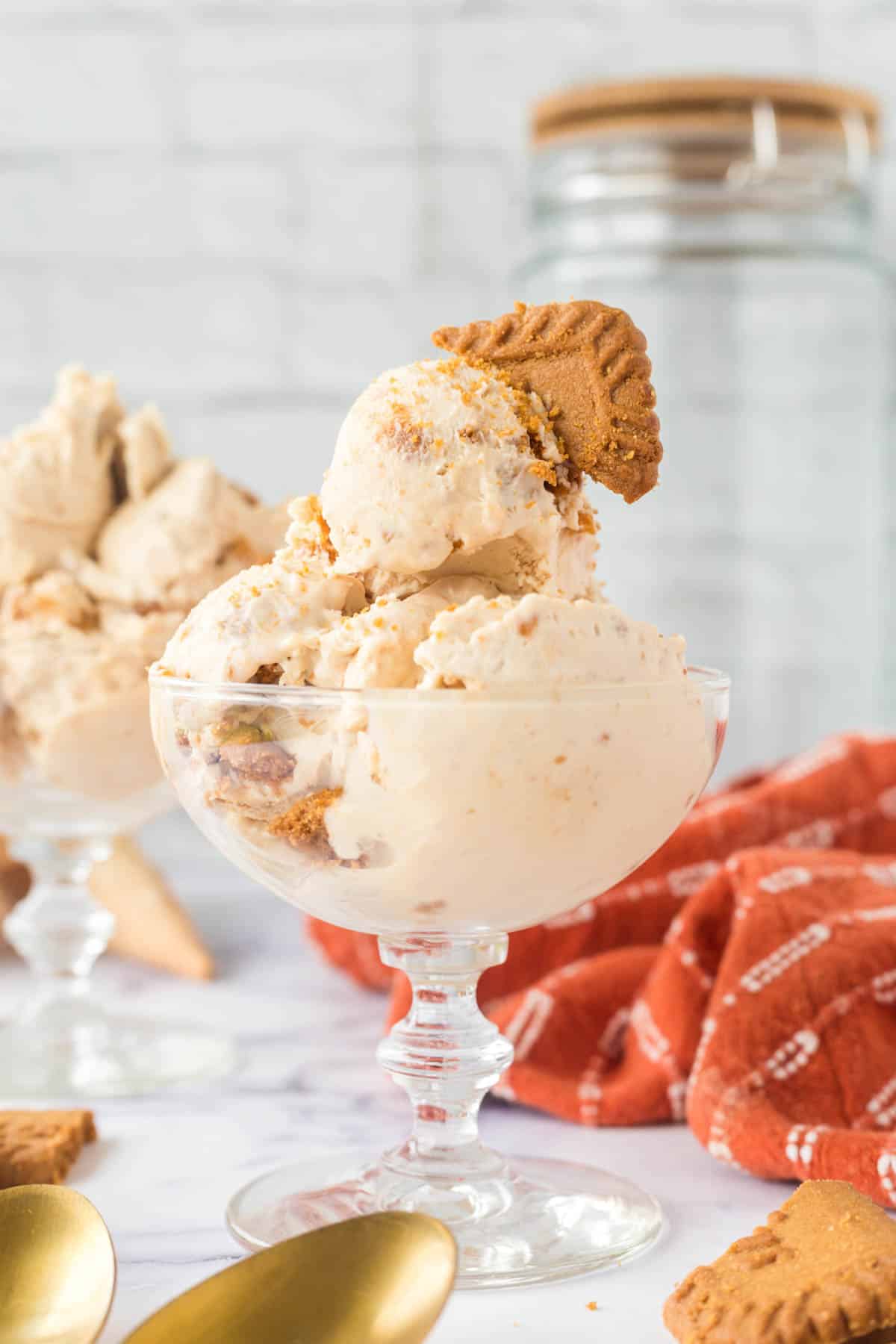 Scoops of No-Churn Biscoff Ice Cream served in a glass dessert bowl.