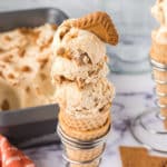 A waffle cone filled with no-churn biscoff ice cream garnished with a cookie.