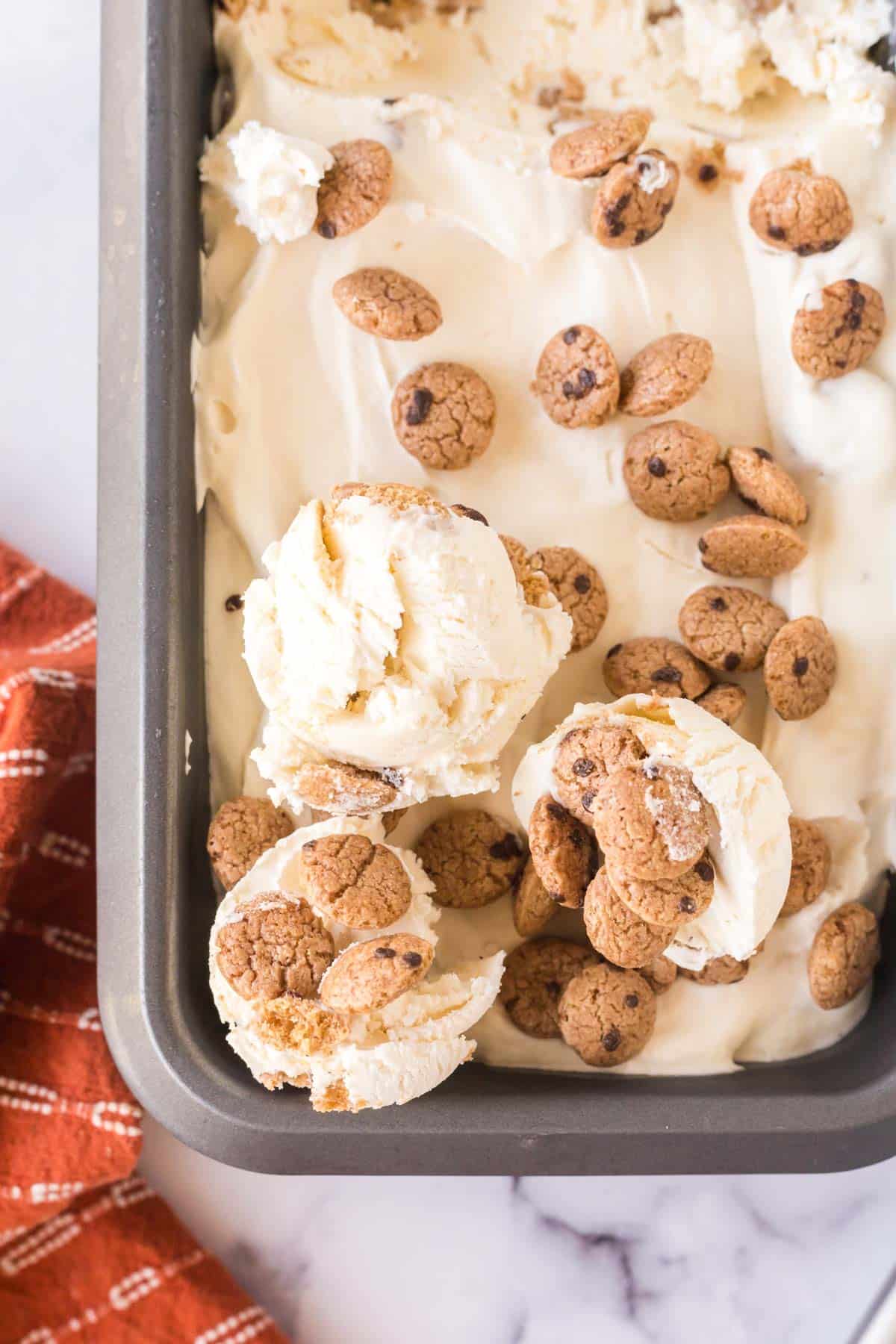A pan on no-churn chocolate chip cookie ice cream with 3 scoops ready to serve.