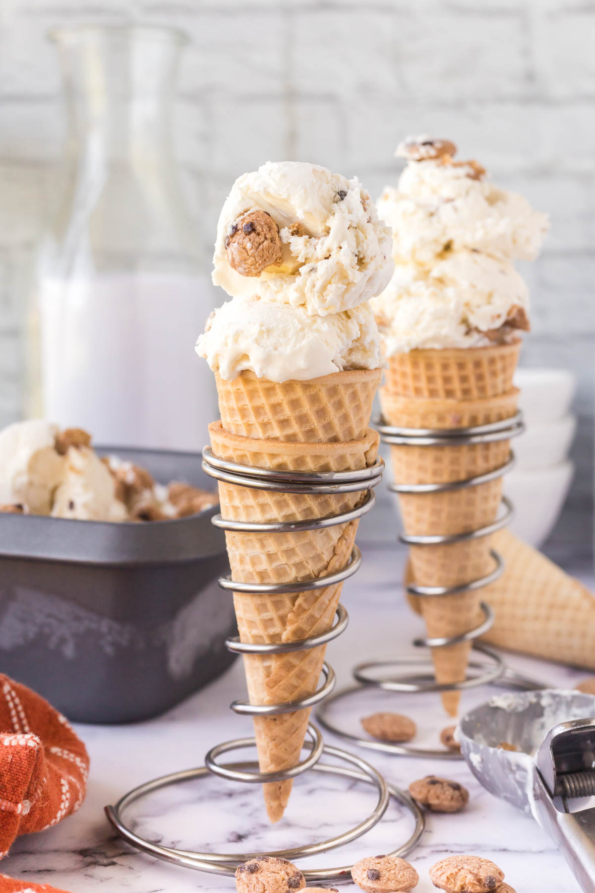 Two waffle cones filled with no-churn chocolate chip cookie ice cream.