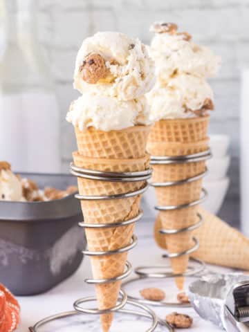 Two waffle cones filled with no-churn chocolate chip cookie ice cream.