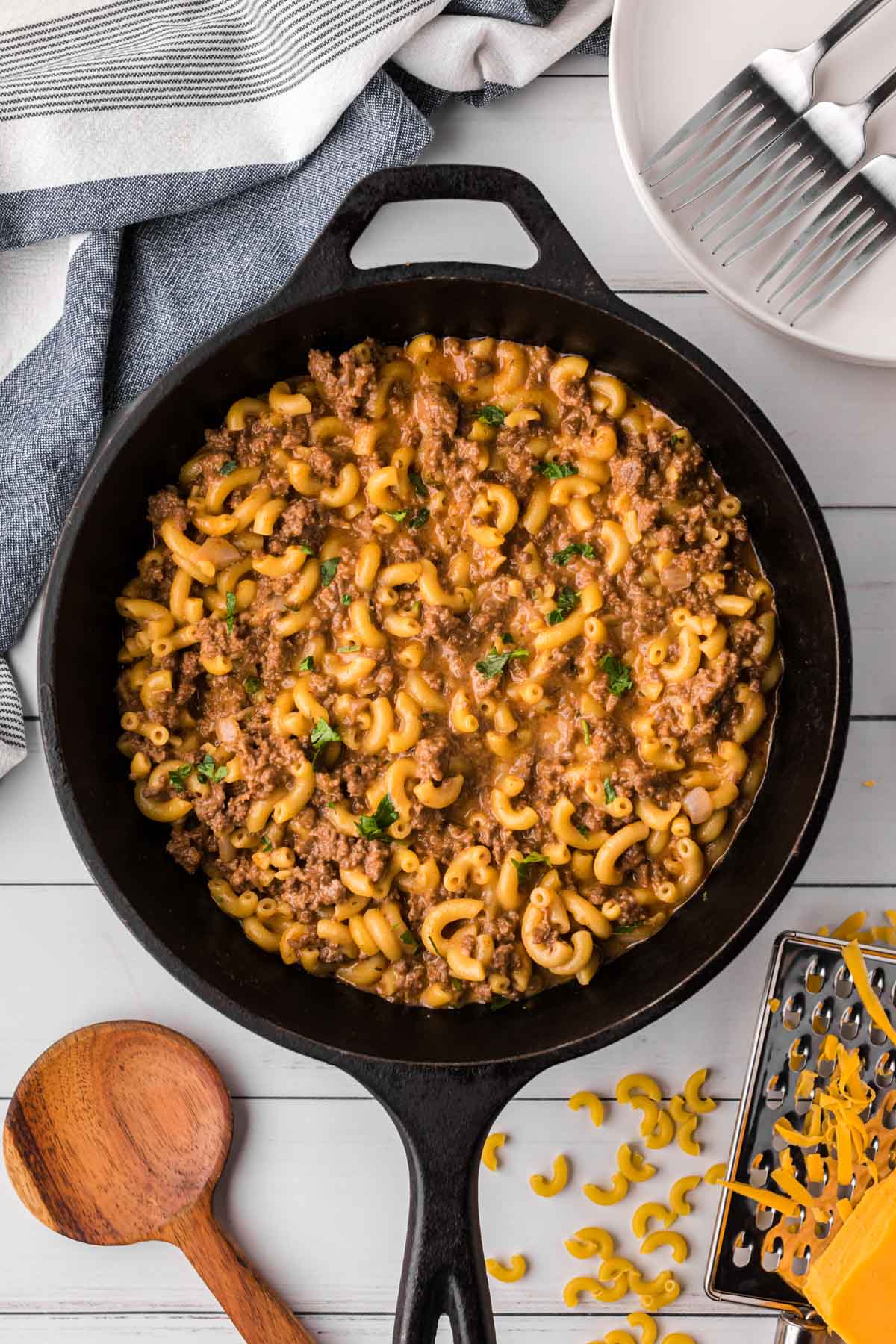 A cast iron skillet full of cheesy hamburger skillet.