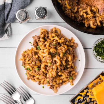 A cast iron skillet full of cheesy hamburger skillet.