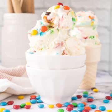 A white bowl filled with scoops of No-Churn M&M Ice Cream.