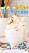 2 white bowls stacked with homemade M&M Ice Cream with colorful M&M candies scattered on the counter.