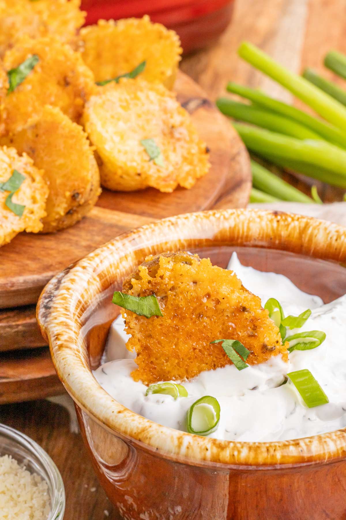 A roasted potato dipped in sour cream dipping sauce.