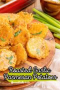 A Pinterest image with text and a wooden plate of parmesan roasted potatoes.