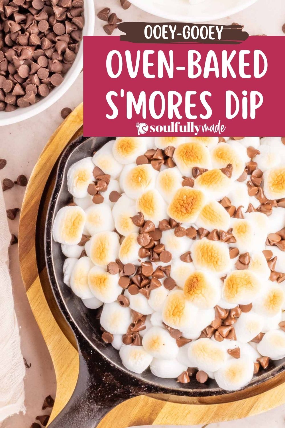 Oven-baked S'mores Dip cooked in a cast itron skillet and topped with chocolate chips.