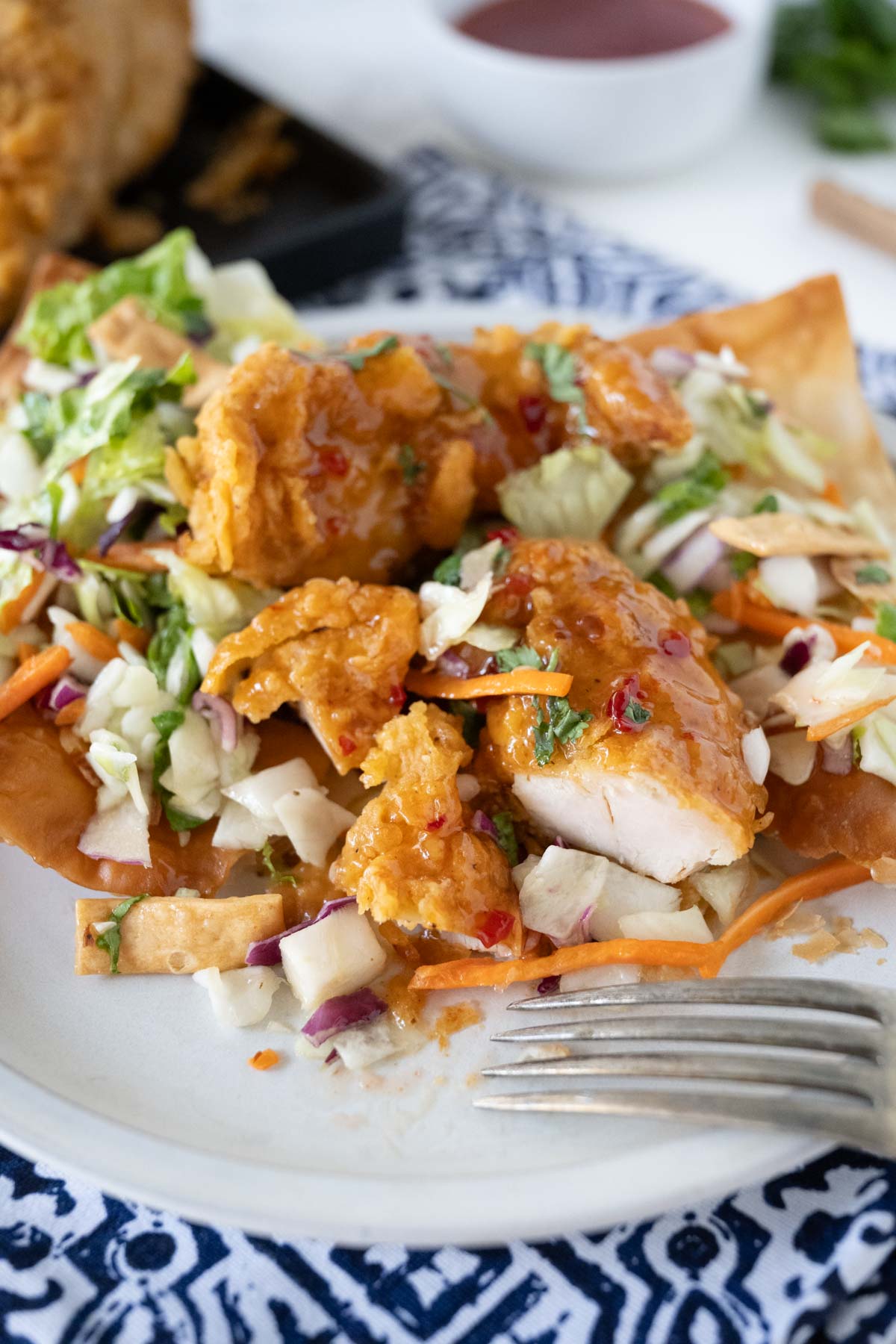 A plate of Asian Chicken Salad Wonton Tostadas after being cut into to eat.