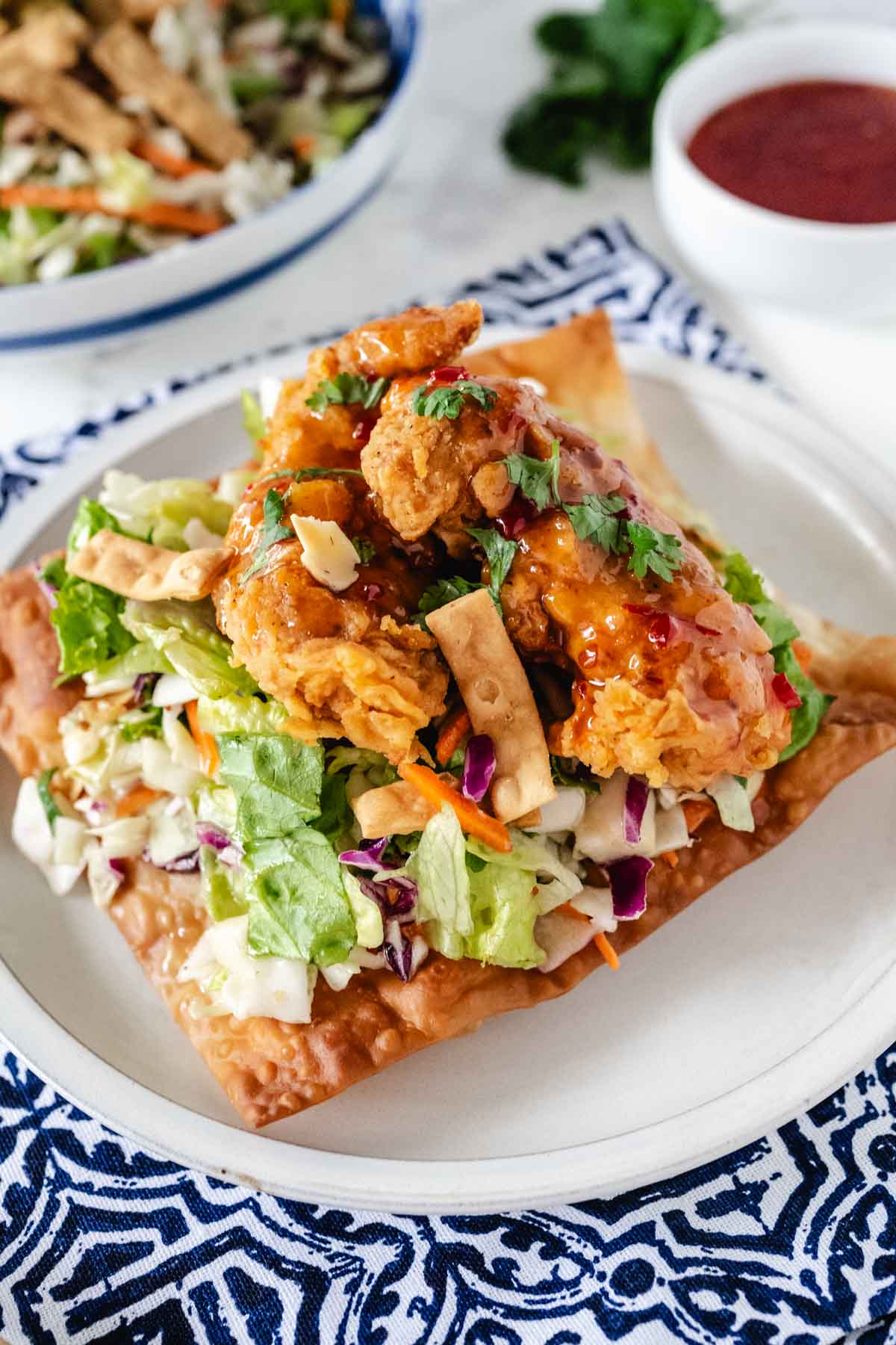 A Crispy Asian Salad stacked on a fried wonton wrapper.