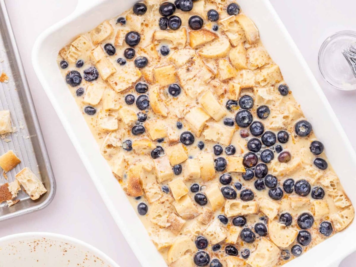 The blueberry french toast casserole with custard poured in and ready to be baked.