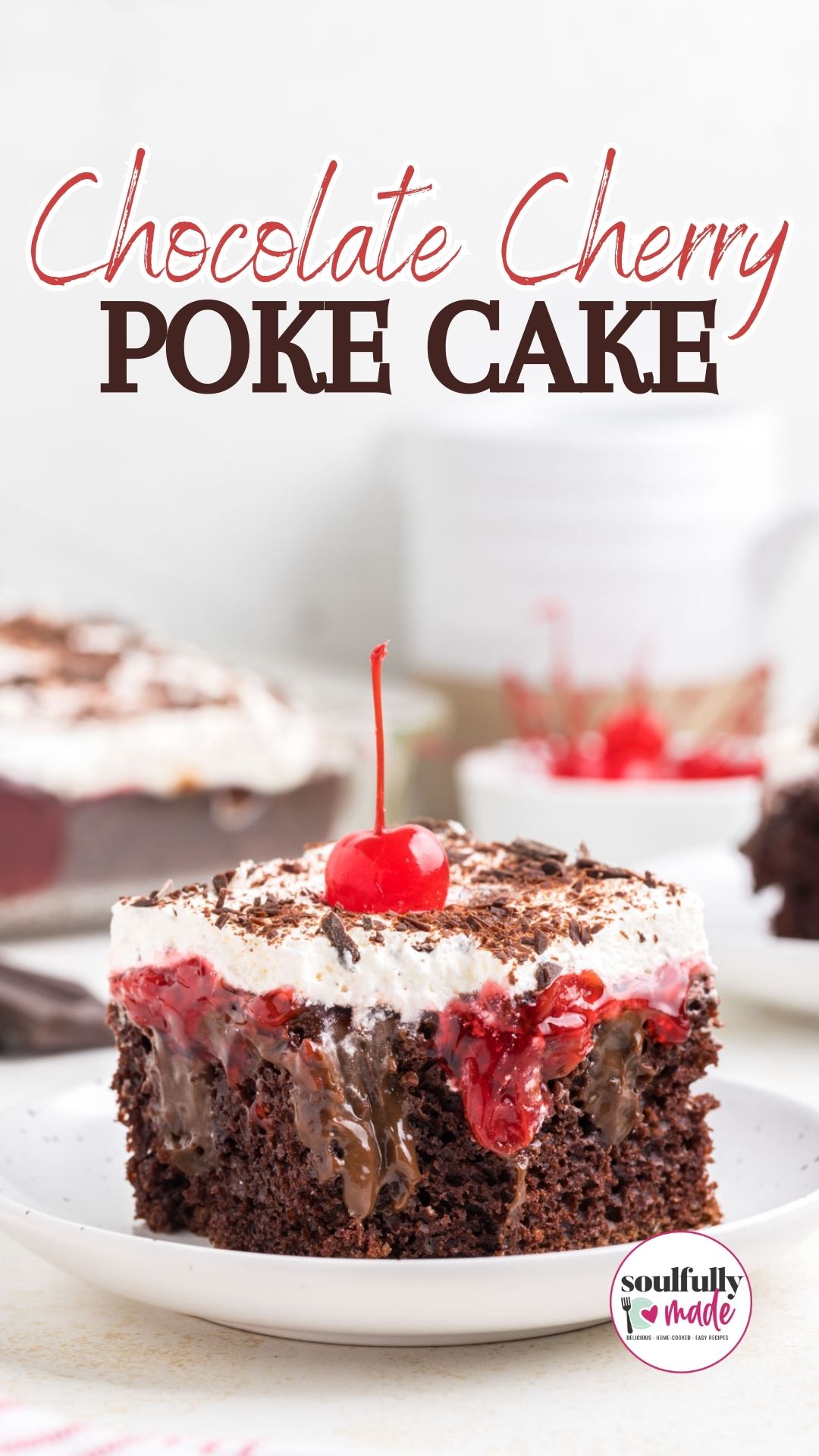 Chocolate Cherry Poke Cake is featured on a white plate and topped with shaved chocolate and a cherry.