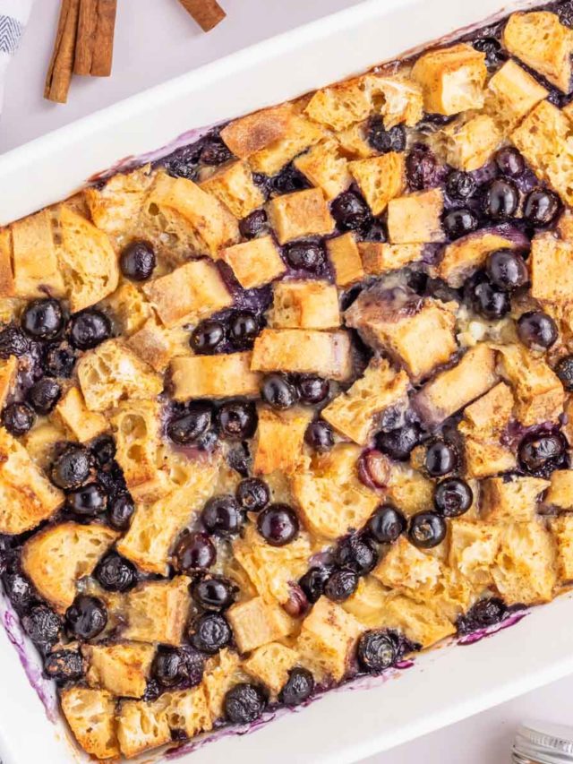 An up close overhead image of the blueberry french toast casserole in a white baking dish.