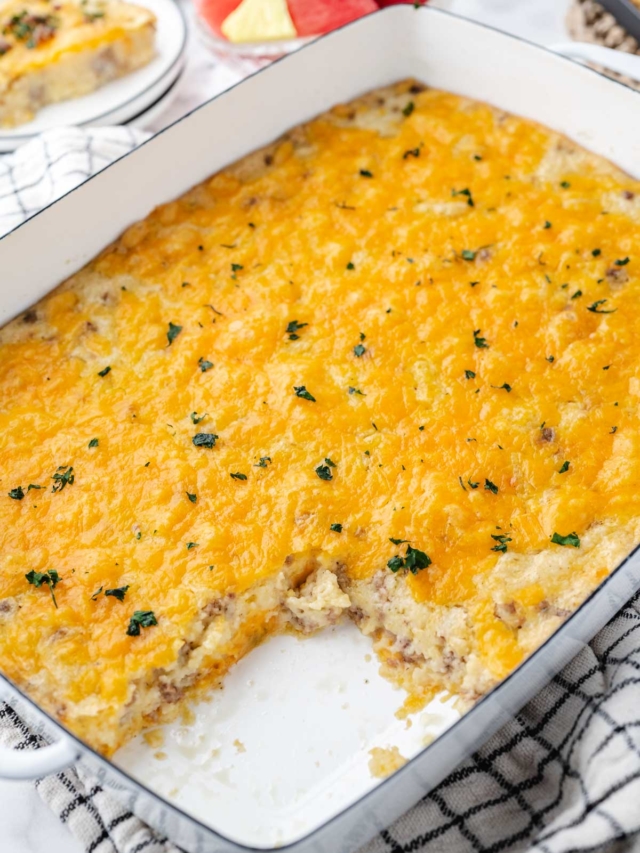 Grits and Sausage Casserole with a serving removed from the serving pan.