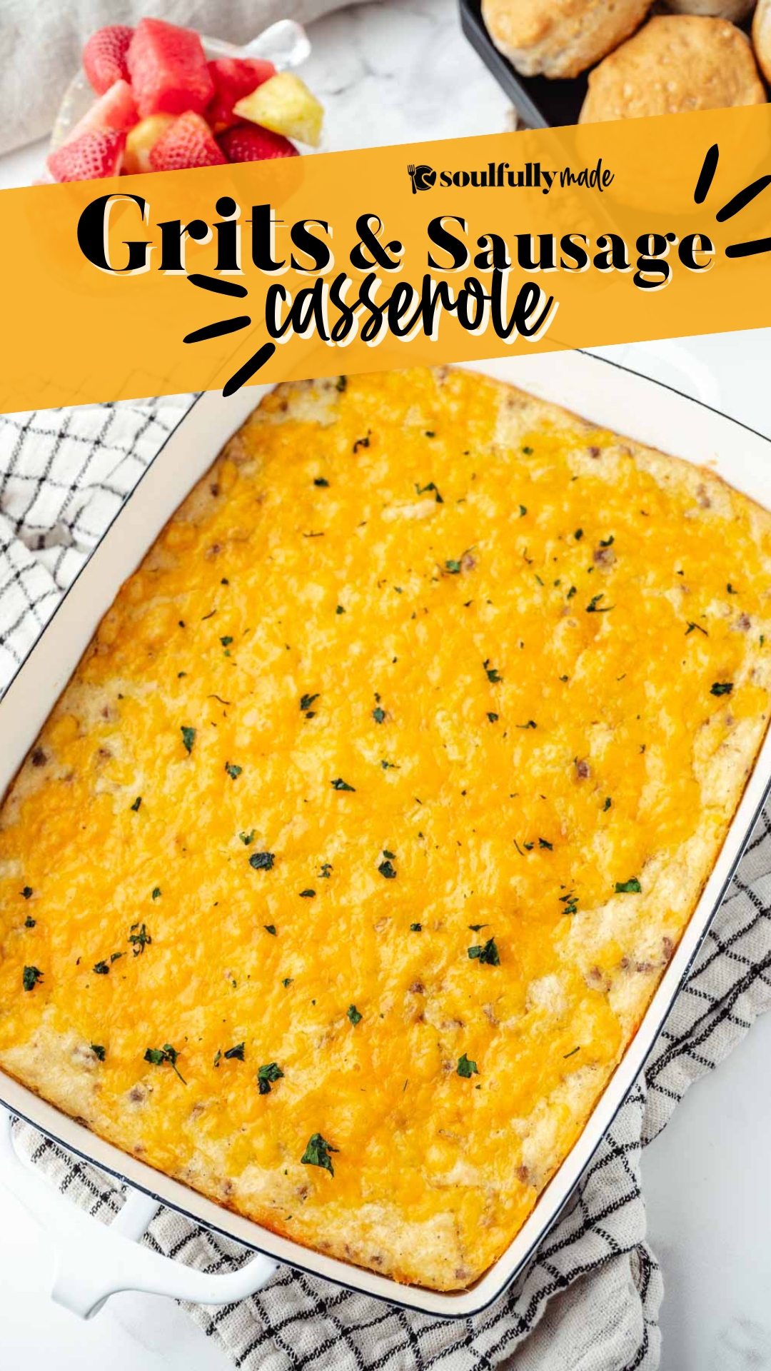 A white casserole dish filled with Sausage and Cheese Grits Casserole.