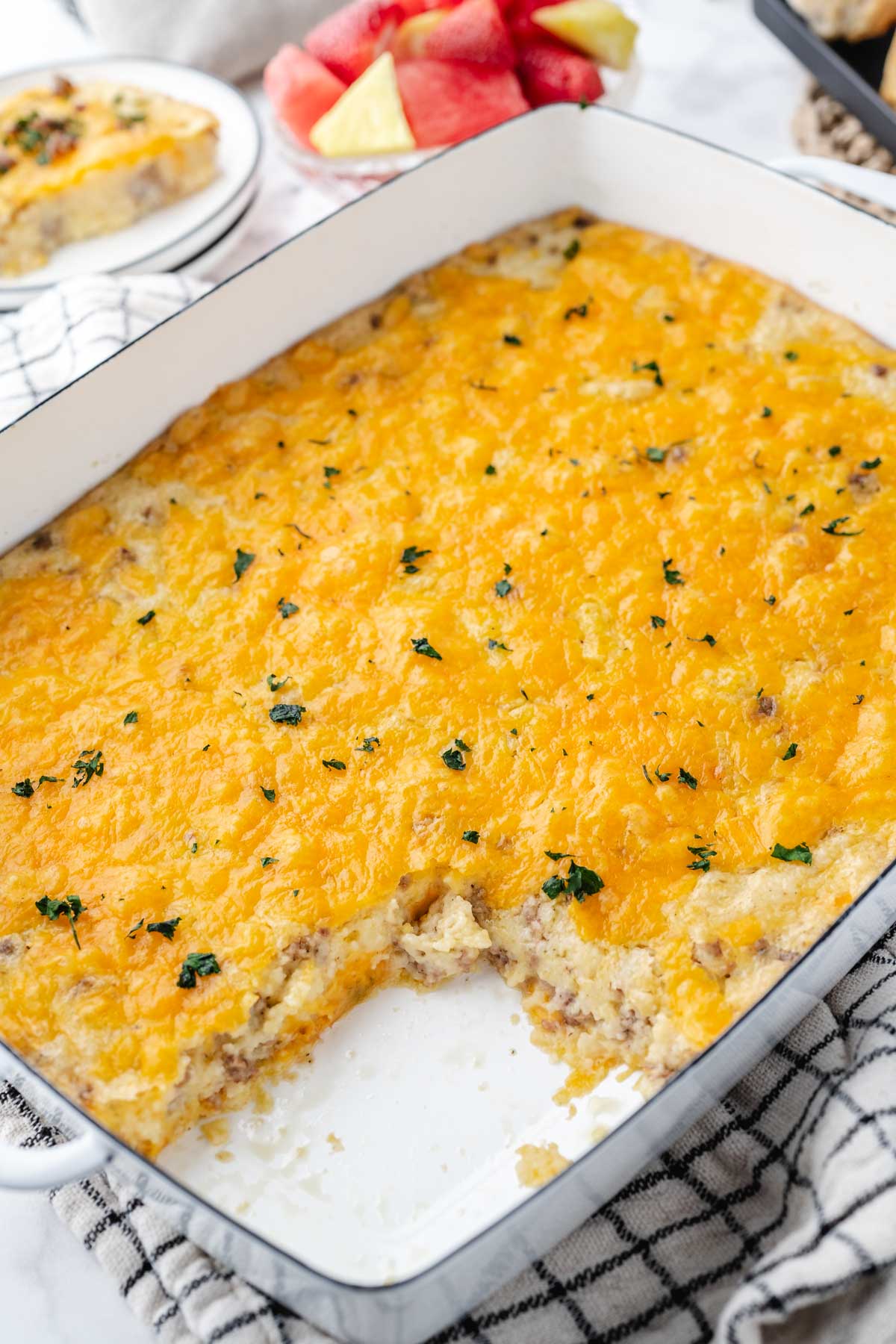 Grits and Sausage Casserole with a serving removed from the serving pan.