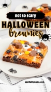 Not so scary Halloween Brownies are featured on a white plate with lttle spiders and a balck and white tea towel.