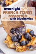 A Pinterest image of a scoop of blueberry french toast casserole being scooped onto a white plate.