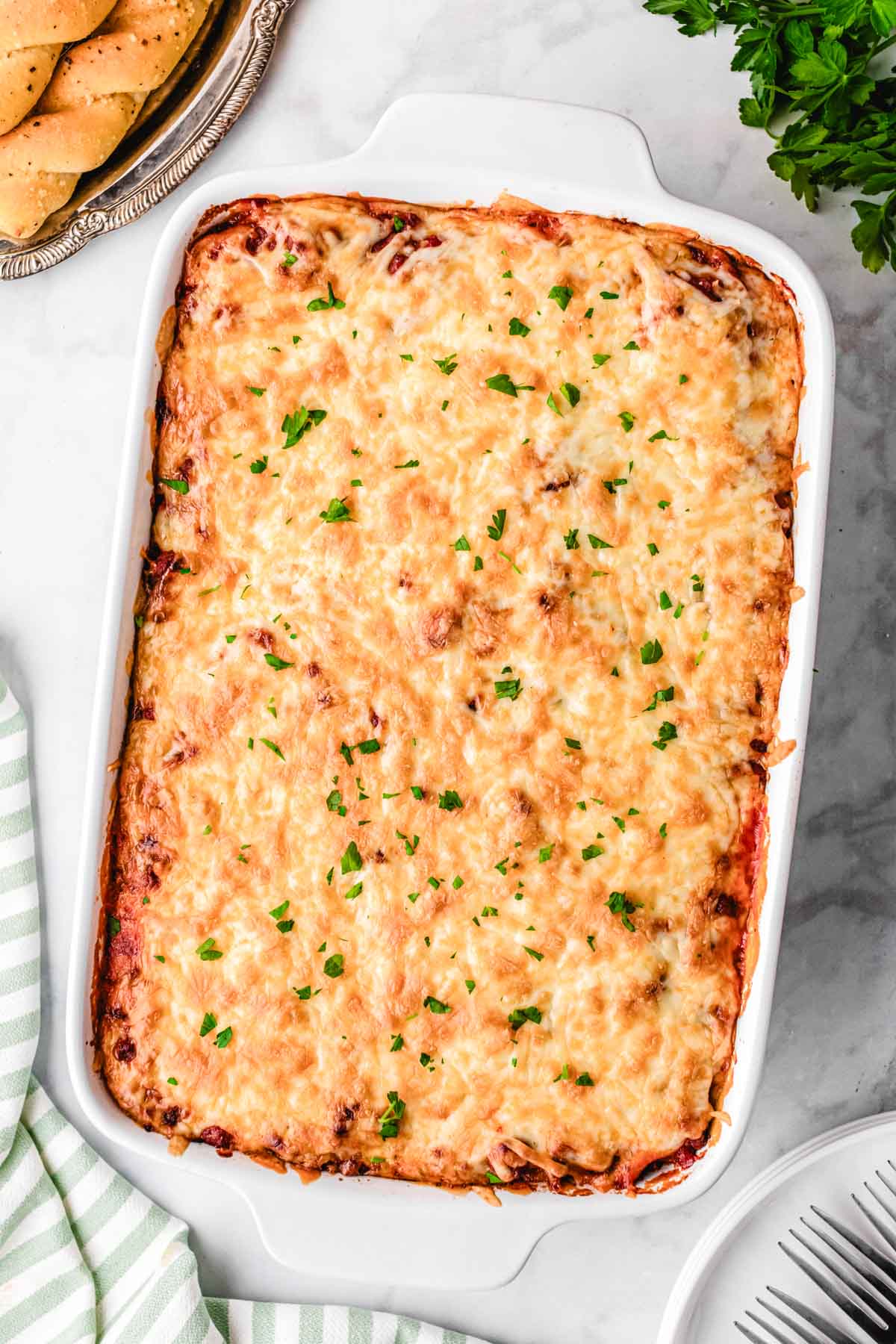 Baked spaghetti fresh out of the oven with melted gooey cheese on top.