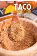 Taco Seasoning is better than store bought in this shot of a wooden spoon showing all the spices mixed in a bowl.