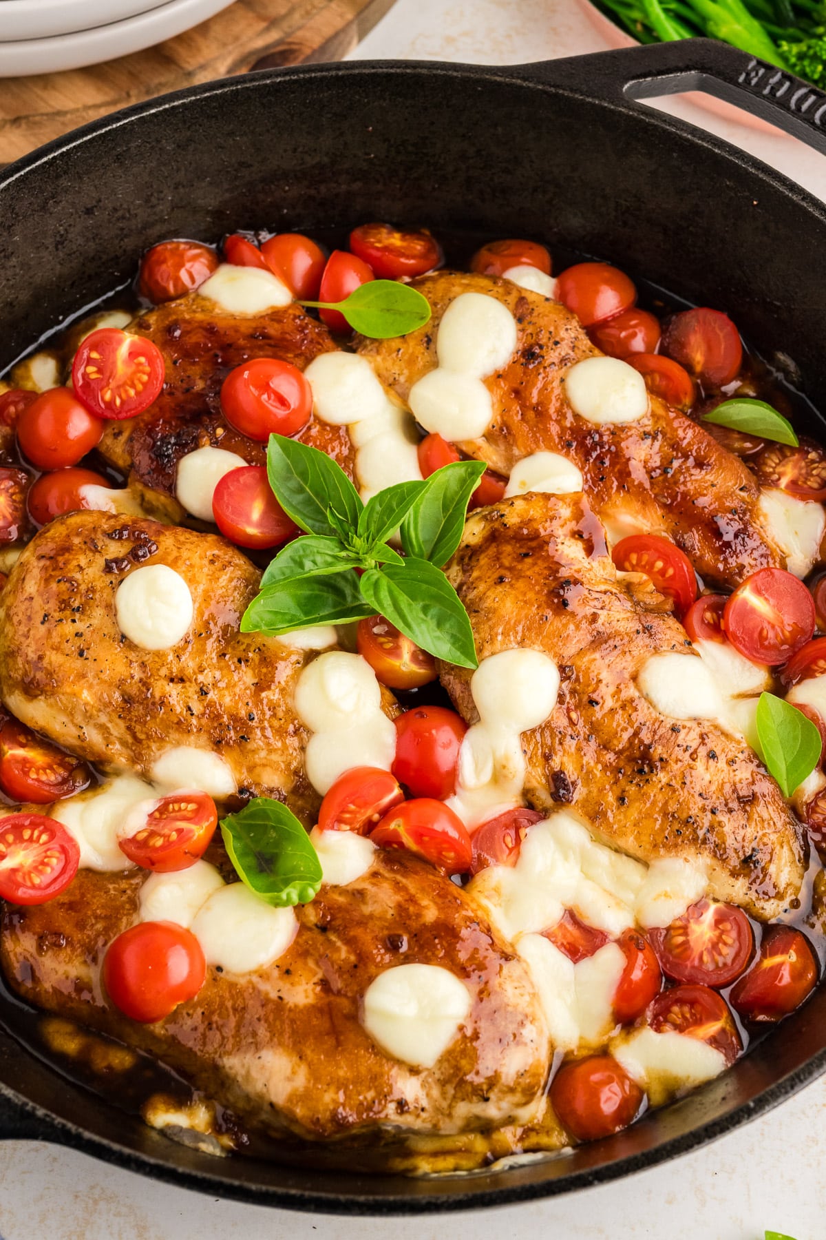 A chicken dish in a black skillet.