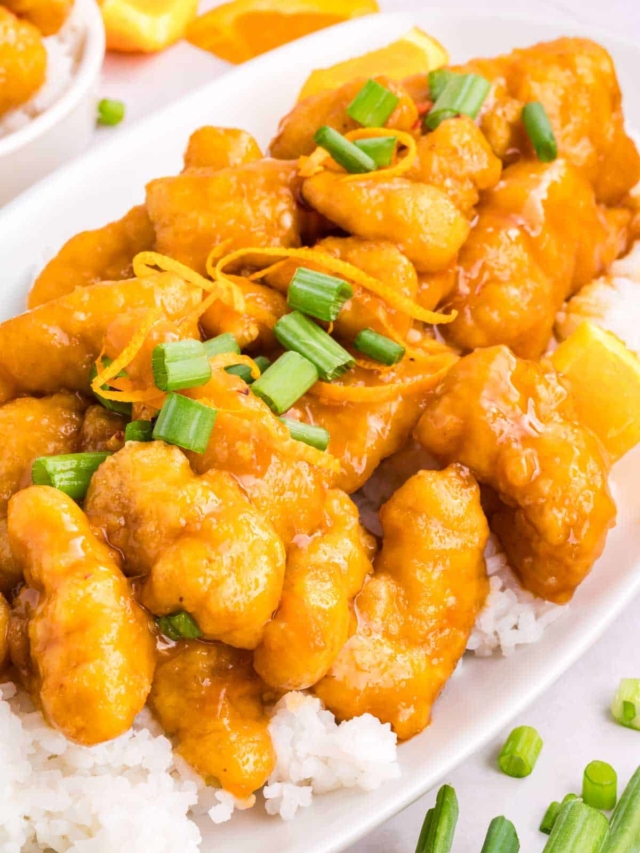 Sliced green onion on breaded chicken tossed with Chinese orange sauce.
