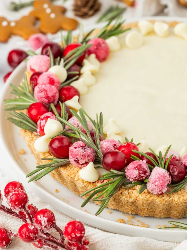 Cranberries and white chocolate chips on top of a Christmas cranberry tart.