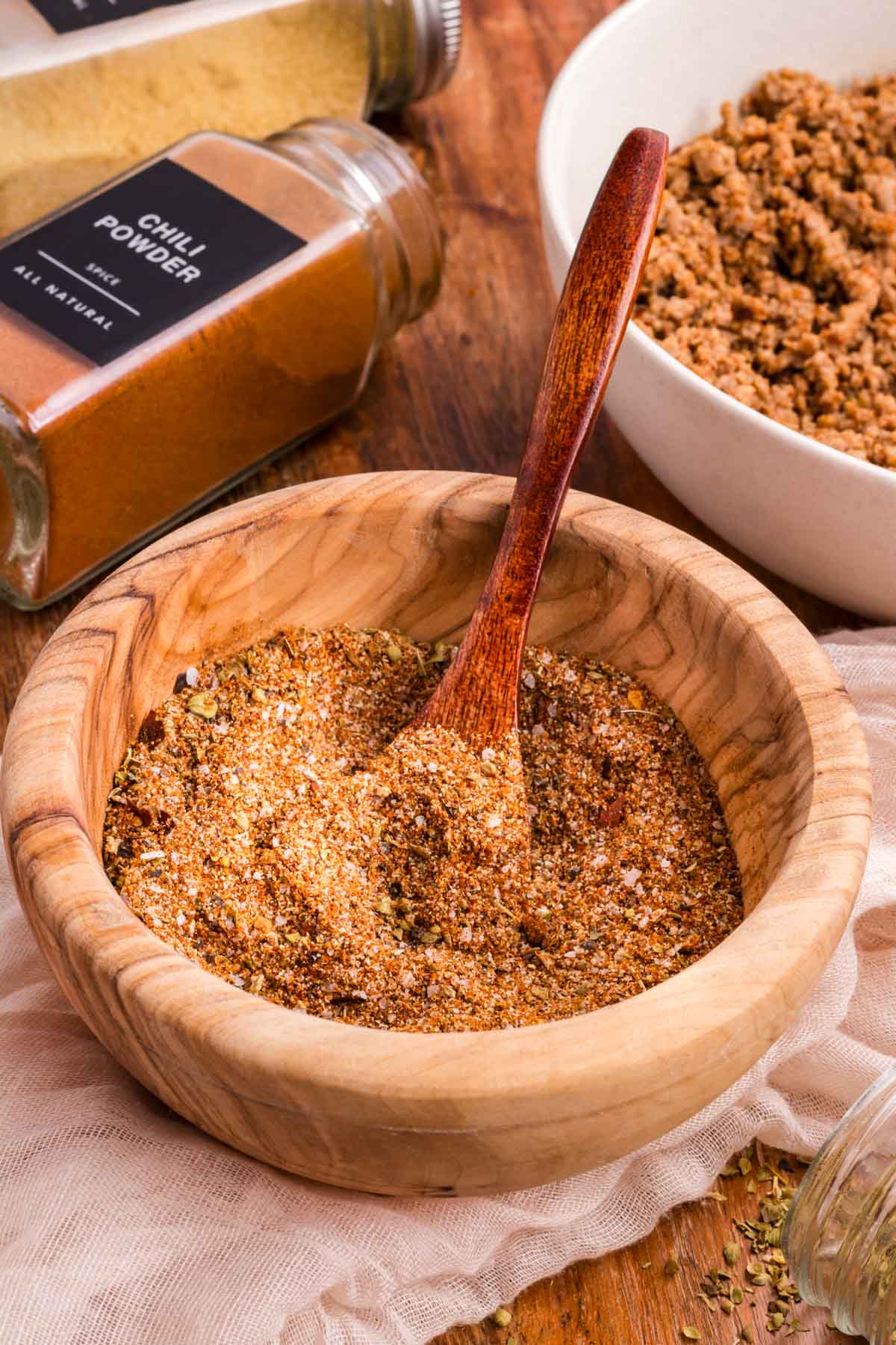Homemade taco seasoning in a wooden bowl.