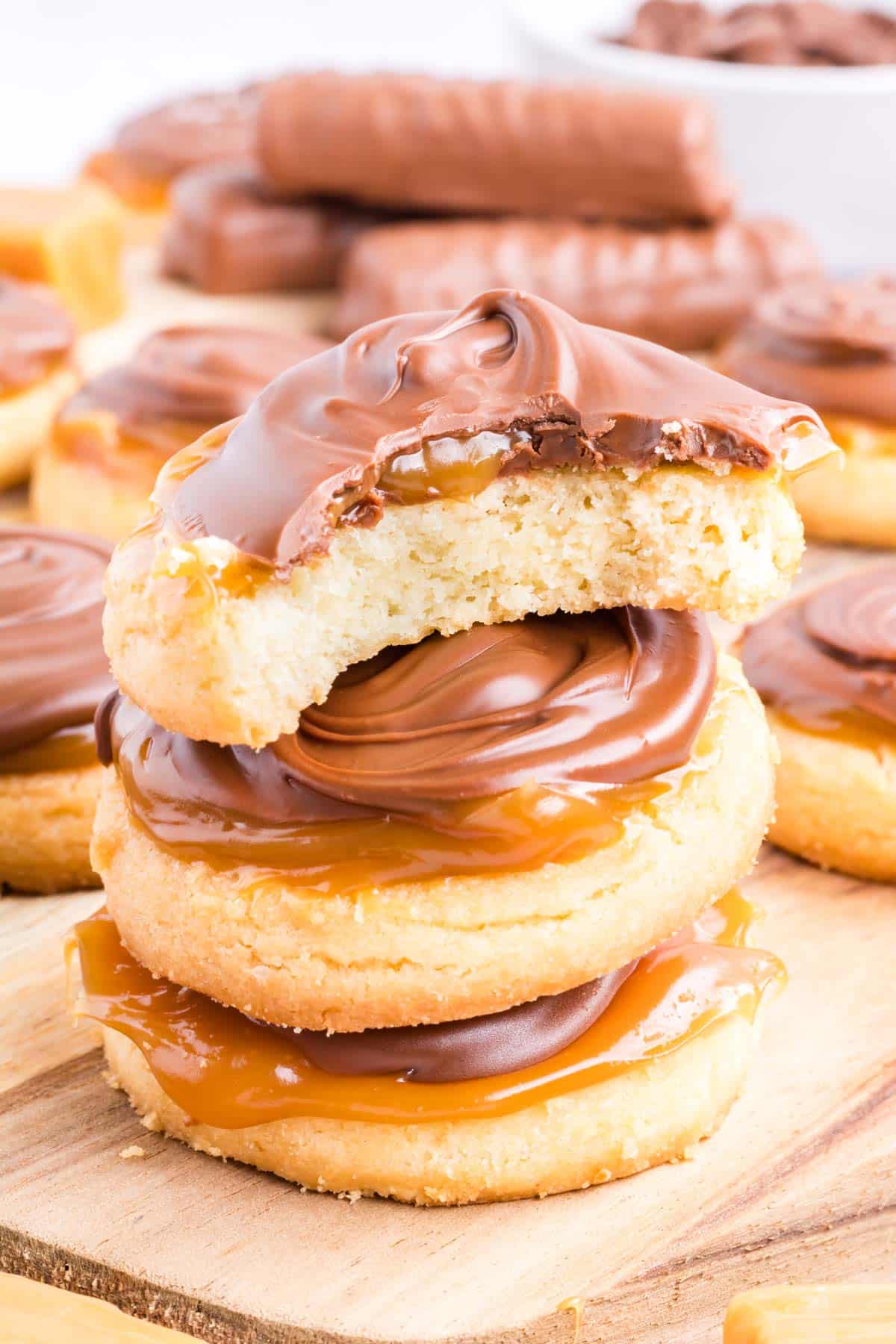 A stack of cookies with one a bite taken out of it.